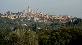 Medieval 12th C town of brick. Surrounded by outer wall,rolling hills,olive trees and vineyards and Cypress trees. It is amazingly well preserved. 14 stone towers still stand within the walls.